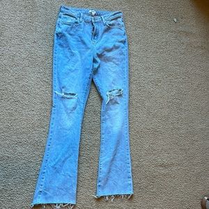Flare jeans with distressed knees